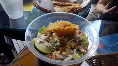 Romaine lettuce topped with black beans ,sour cream and fried pacific dory.